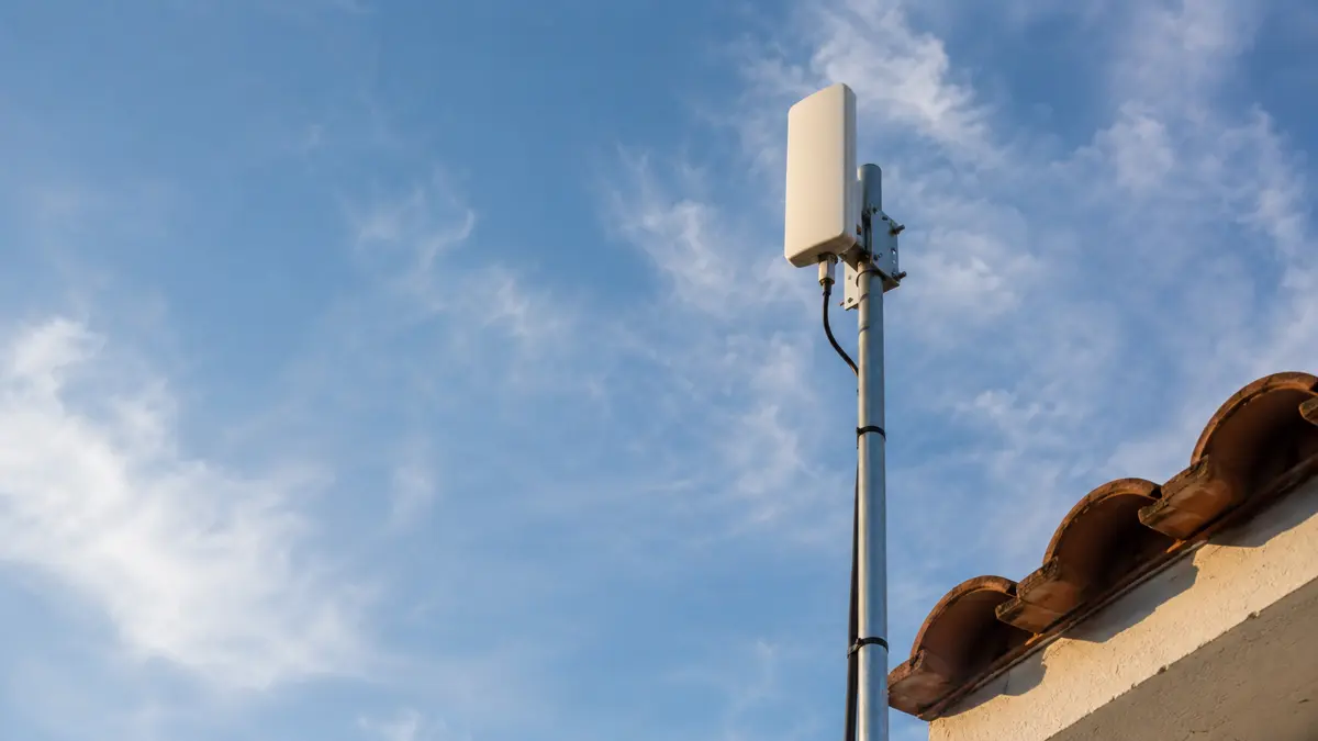 Antena de red inalambrica montada en un mastil sobre un techo